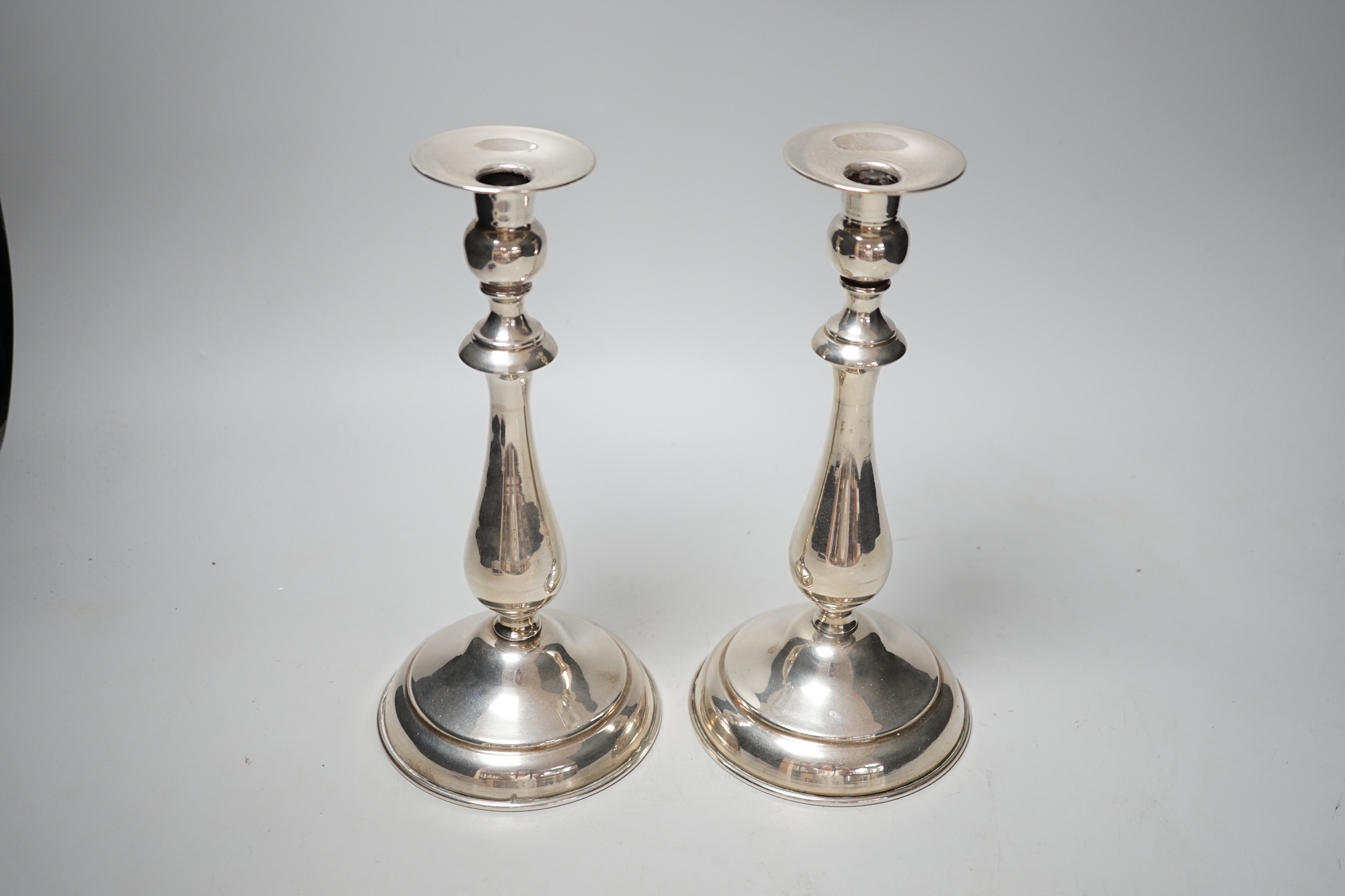 A pair of continental white metal candlesticks, stamped SK 900, height 25.3cm, gross 18.3oz.